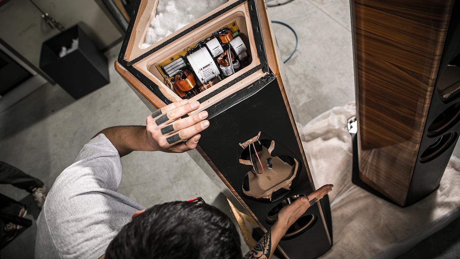 Open speaker cabinet showing internal components during assembly