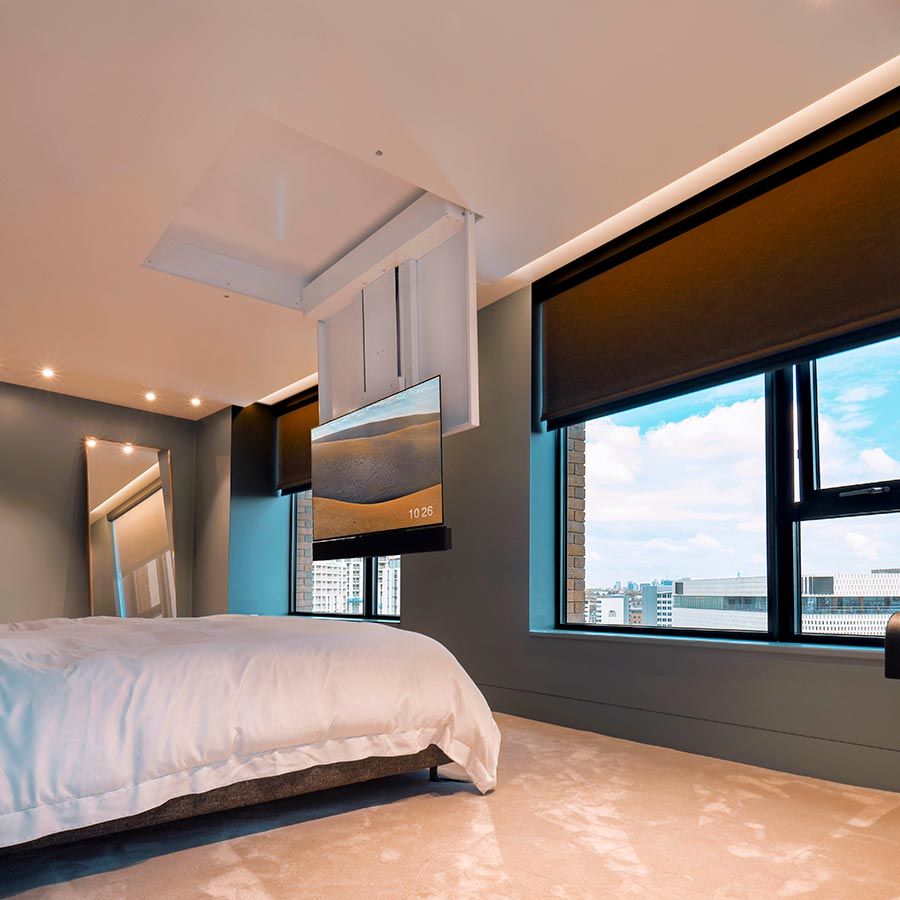 Sheer window shades covering tall windows in a modern open living space