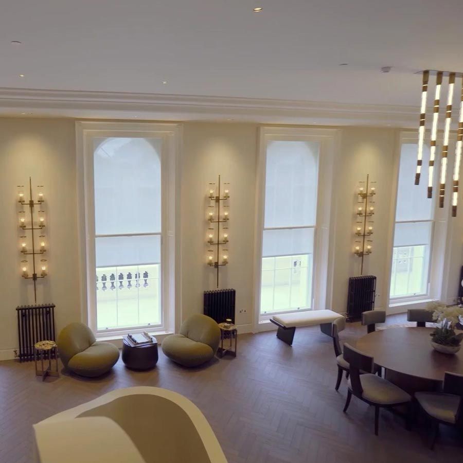 Bedroom with motorised shades and a ceiling mounted TV lift in motion