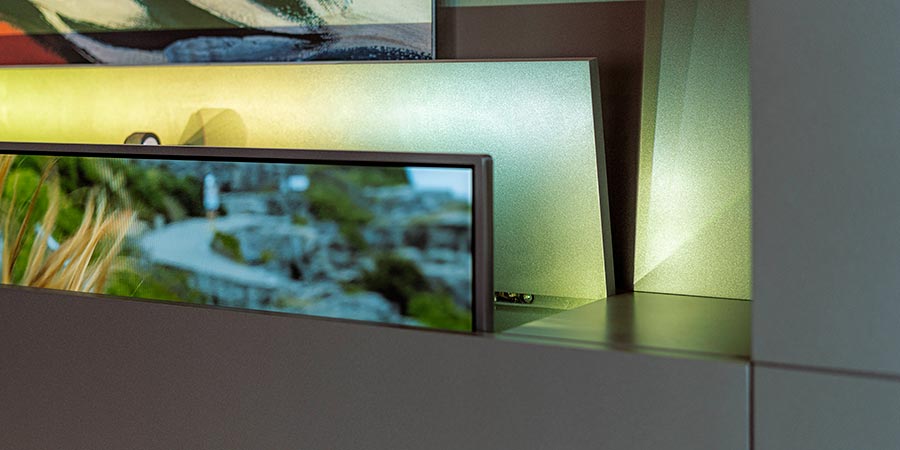 TV lowering from a ceiling in a modern bedroom