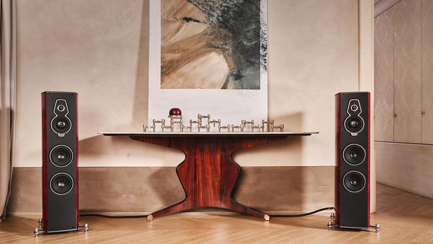 Floor standing speaker positioned beside a designer table in an elegant room