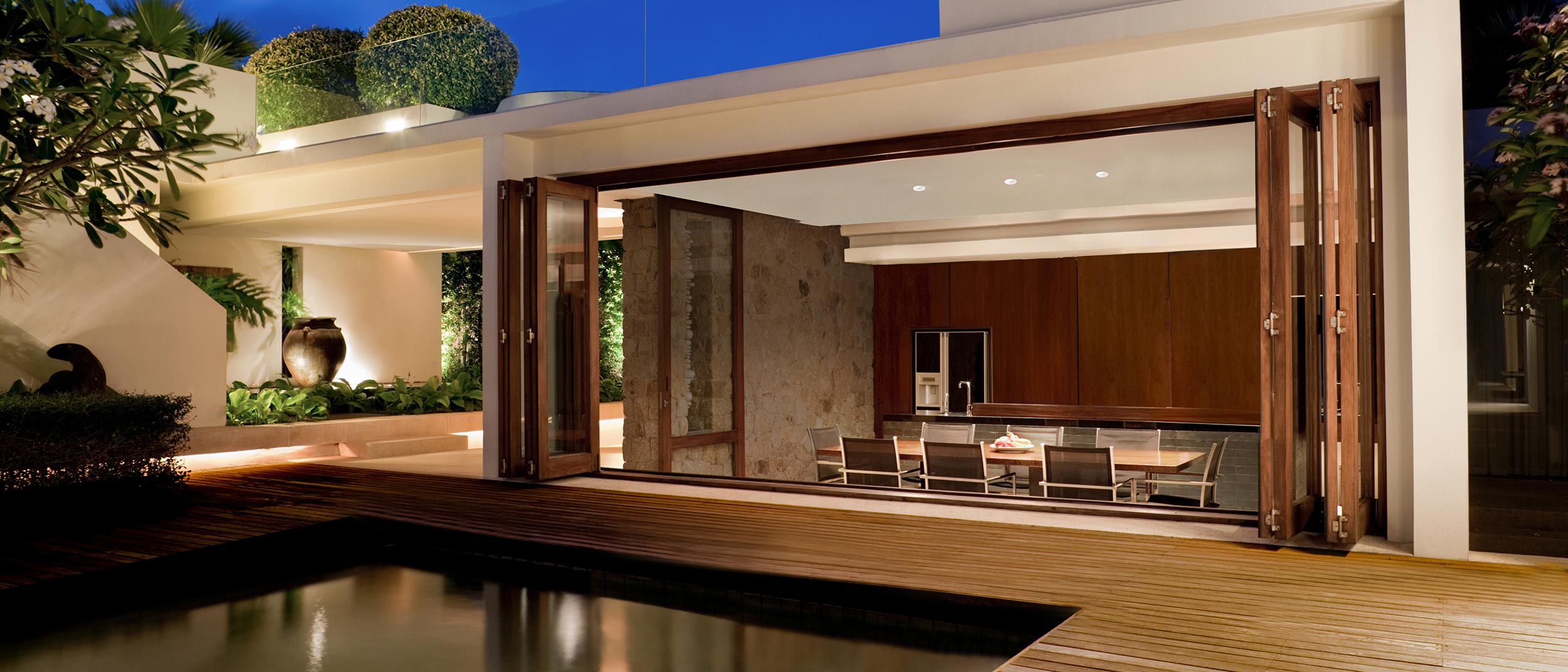 Open patio dining area with soft evening lighting and wood accents