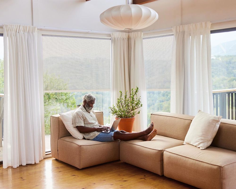 crestron drapery system in home with view of forest