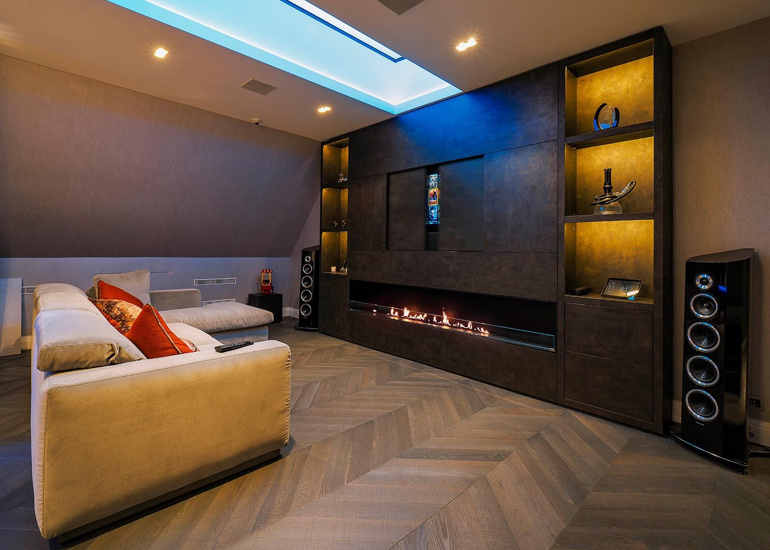 Media room with long fireplace and large sectional sofa