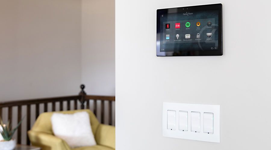 Control4 touch panel on wall above light switches