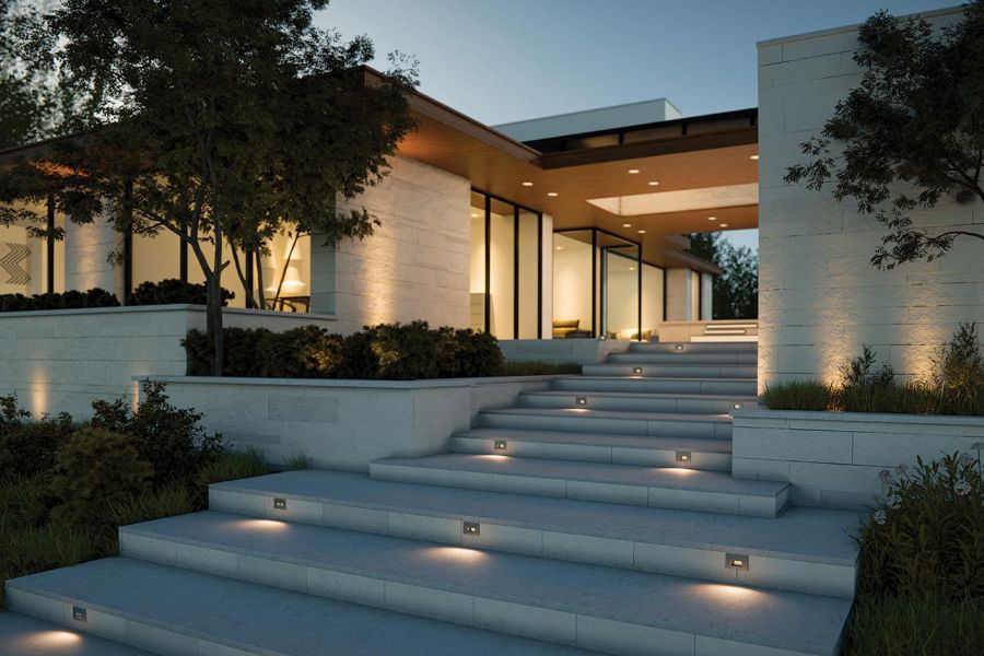 Modern home entrance with wide steps highlighted by step lights